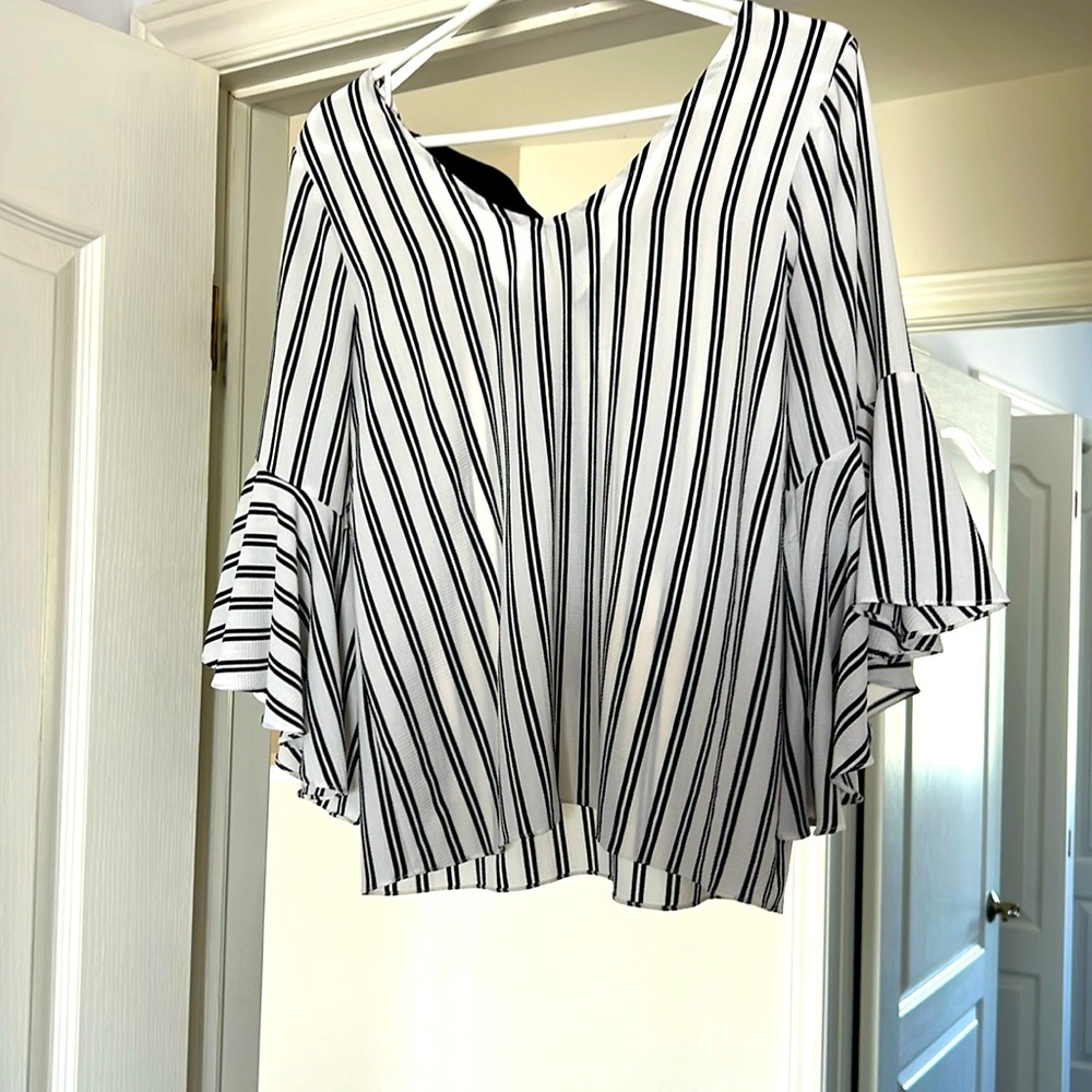 Straight cut, flared sleeve blouse with black tie up in back. Green Envelope.